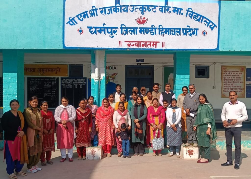 School Management Committee members gathered outside the main building of PM Shri Govt Utkrish Sr Sec School, Dharampur.